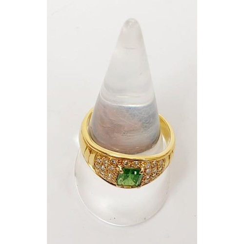 11 - An 18ct gold diamond and emerald ring, size T/U, gross weight 7.7g. UK shipping £14. We combine ship... 