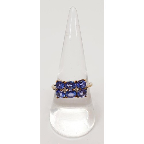 22 - A hallmarked 9ct gold ring set with tanzanite and diamond, size Q/R, gross weight 2.5g. UK shipping ... 