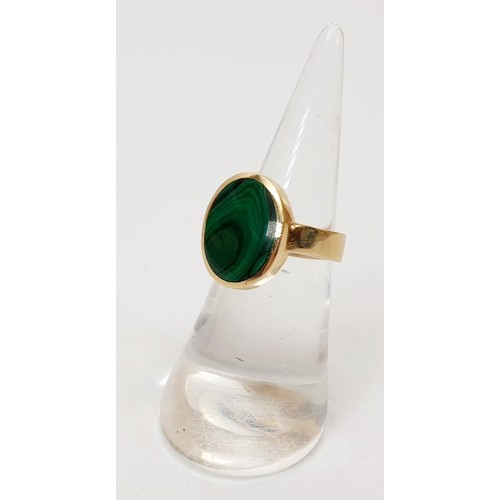 23 - A hallmarked 9ct gold and malachite signet ring, size K, gross weight 5.9g. UK shipping £14. We comb... 