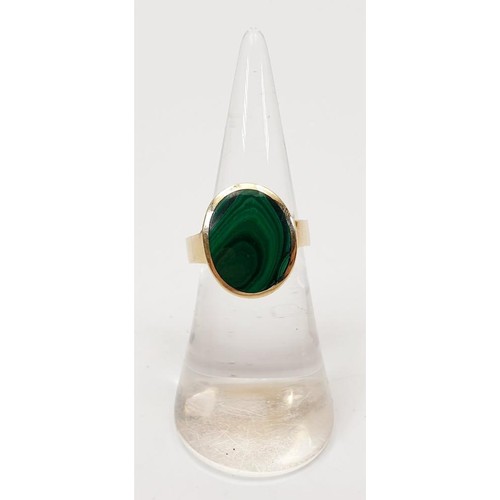 23 - A hallmarked 9ct gold and malachite signet ring, size K, gross weight 5.9g. UK shipping £14. We comb... 