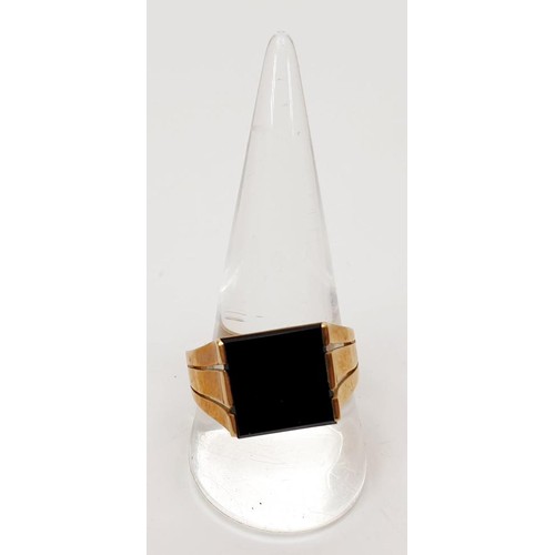 24 - A hallmarked 9ct gold signet ring set with black stone, size V/W, gross weight 5.5g. UK shipping £14... 