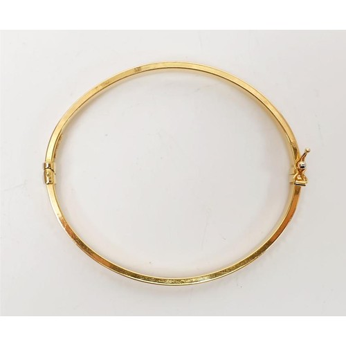 36 - A 9ct gold bangle with a Greek Key pattern. UK shipping £14. We combine lots.