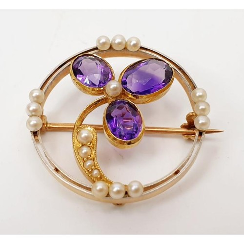 46 - A yellow metal brooch set with amethysts and seed pearls, gross weight 4.3g. UK shipping £14. We com... 