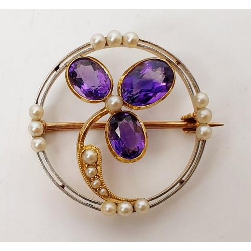 46 - A yellow metal brooch set with amethysts and seed pearls, gross weight 4.3g. UK shipping £14. We com... 