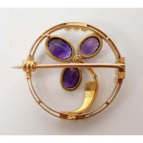 46 - A yellow metal brooch set with amethysts and seed pearls, gross weight 4.3g. UK shipping £14. We com... 