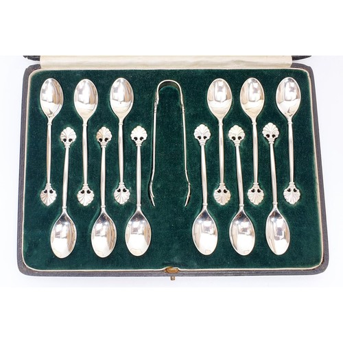 63 - A set of twelve cased silver hallmarked Mapin and Webb coffee spoons together with sugar tongs, weig... 