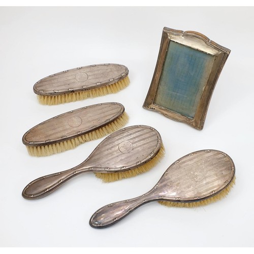 69 - A silver backed dressing table brush set, Birmingham 1919 A/F together with a silver hallmarked phot... 