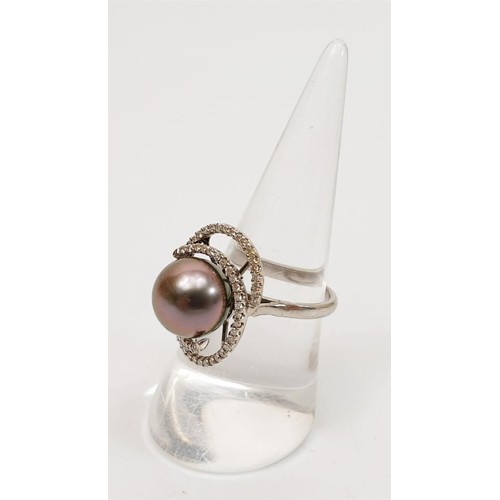 10 - A hallmarked 18ct white gold ring set with a Tahitian pearl and diamond retailed by Ogden's Jeweller... 