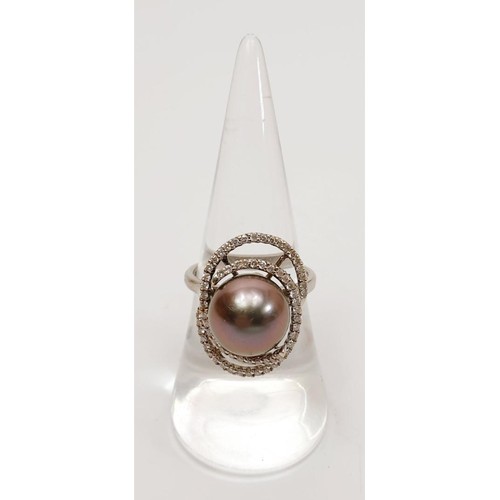 10 - A hallmarked 18ct white gold ring set with a Tahitian pearl and diamond retailed by Ogden's Jeweller... 