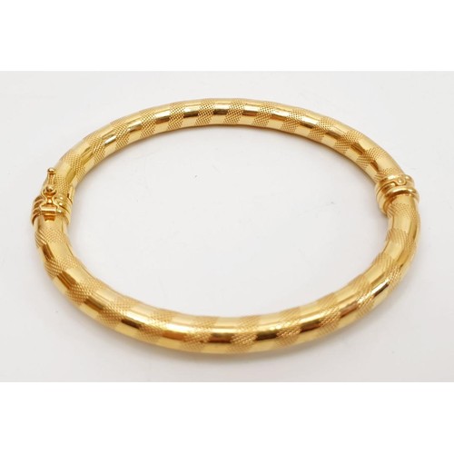 16 - A 9ct gold bangle, weight 8.7g. UK shipping £14. We combine lots.