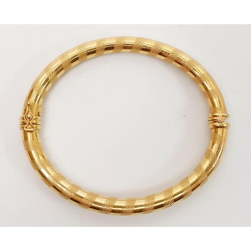 16 - A 9ct gold bangle, weight 8.7g. UK shipping £14. We combine lots.