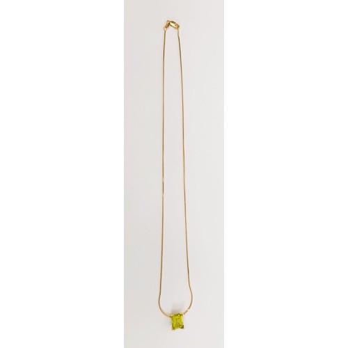 23 - An 18ct gold pendant set with a peridot on an 18ct gold chain, chain length 18