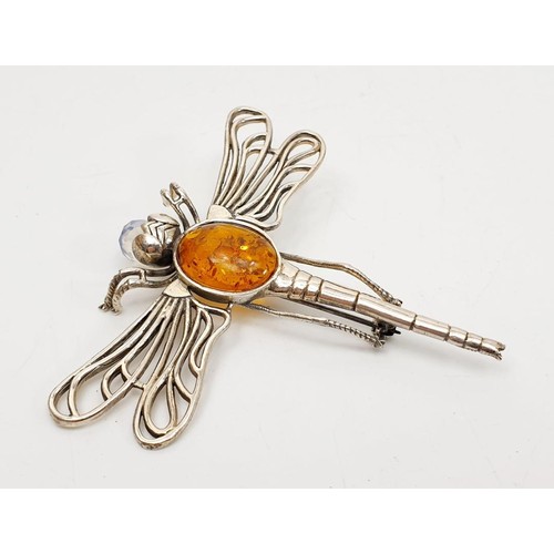 34 - A silver brooch in form of a dragonfly set with amber and crystal, length 3