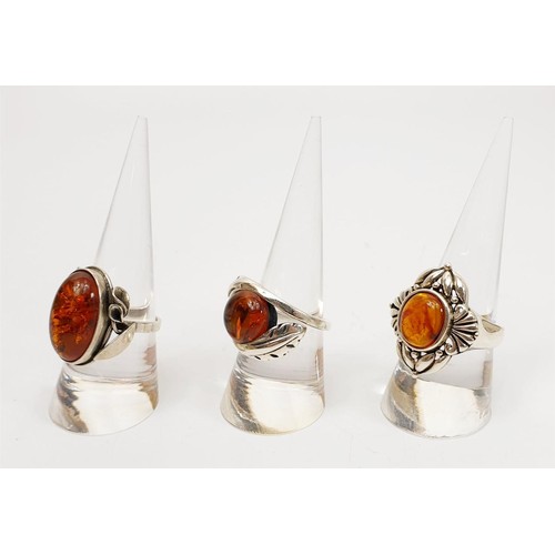 37 - Three silver and amber set rings, gross weight 22g. UK shipping £14. We combine lots.