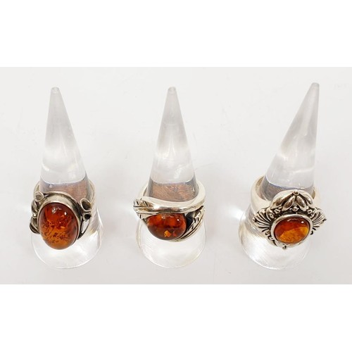 37 - Three silver and amber set rings, gross weight 22g. UK shipping £14. We combine lots.