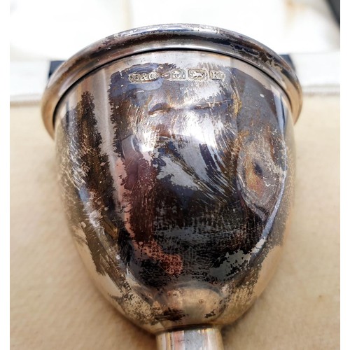 45 - A cased hallmarked silver egg cup and spoon, egg cup A/F, weight 34g, Birmingham 1933 and 1934. UK s... 