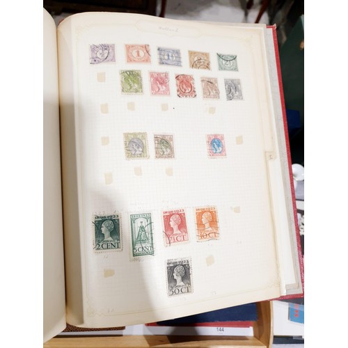 144 - Four stamp albums. UK shipping £14.