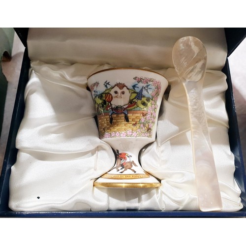 172 - A boxed Halcyon Days Humpty Dumpty ceramic egg cup with a mother of pearl spoon. UK shipping £14.