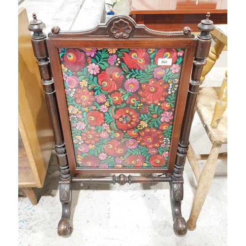 200 - A Victorian mahogany carved fire screen with needlework insert, height 32