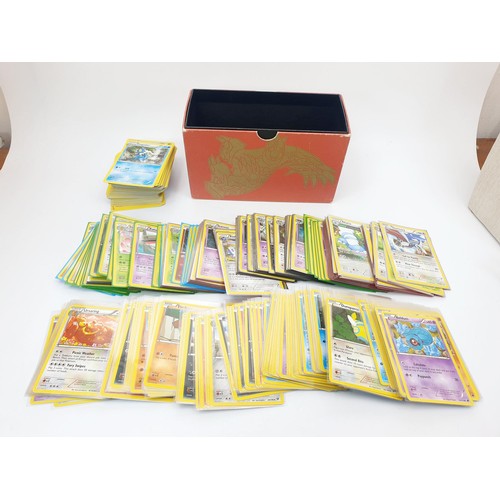 274 - Six boxes of Pokemon cards, some in top load sleeves, spare sleeves and dice. UK shipping £14.