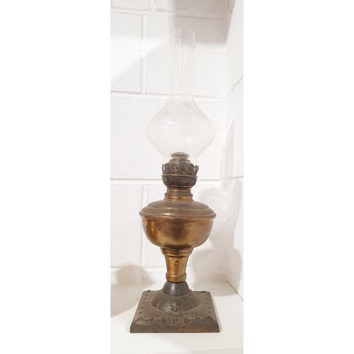 321 - An antique cast iron and oil lamp, height 21.5