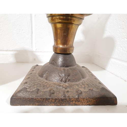 321 - An antique cast iron and oil lamp, height 21.5