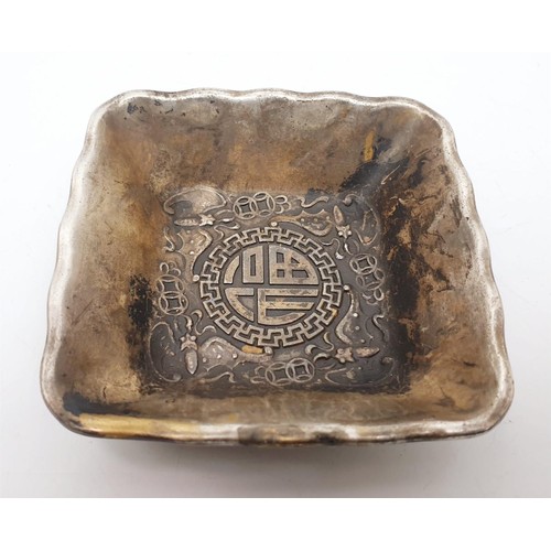 329 - A Chinese metal dish embossed with dragons and Buddhist symbols, a signature to the base, 3