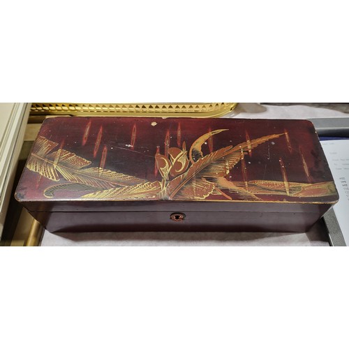 116 - A Japanese lacquered glove box containing a selection of collectables including an Acme Thunderer wh... 