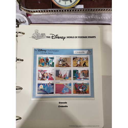 137 - A folder of Disney World of Postage Stamps together with a folder of Royal Mail first day covers. UK... 