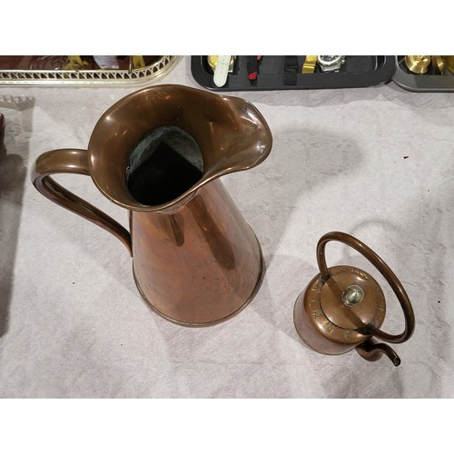 139 - A vintage copper Chinese teapot and an antique copper jug, height 11.25