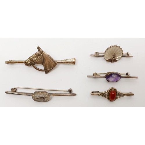 4 - Four silver brooches and one white metal brooch. UK shipping £14.