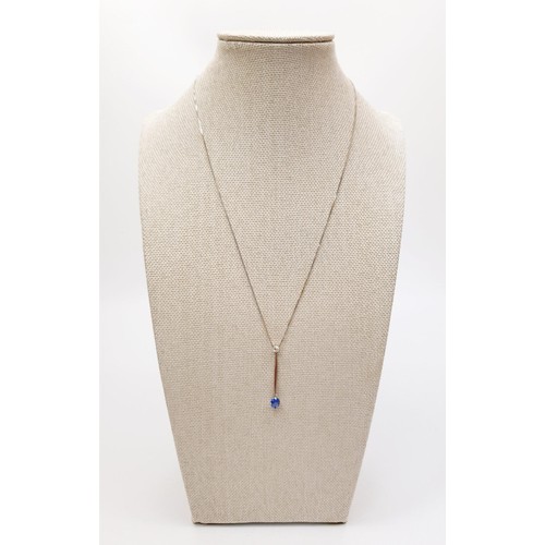 22 - An 18ct white gold pendant set with sapphire and diamond on an 18ct gold chain, chain length 18