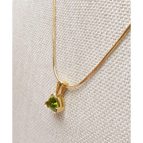 23 - A 14ct gold peridot set pendant on a 14ct gold chain, gross weight 5.7g, chain length 16