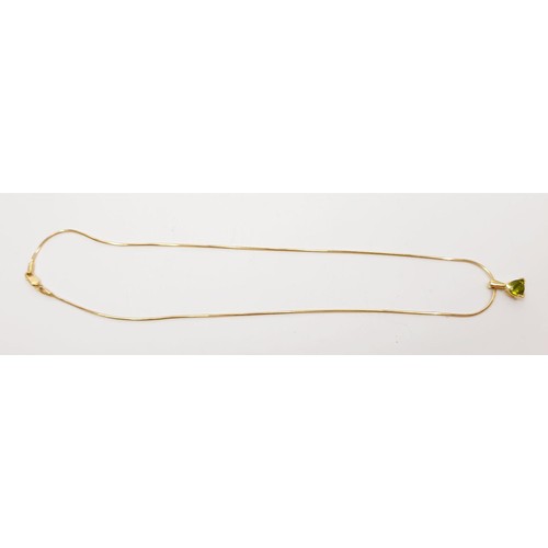 23 - A 14ct gold peridot set pendant on a 14ct gold chain, gross weight 5.7g, chain length 16