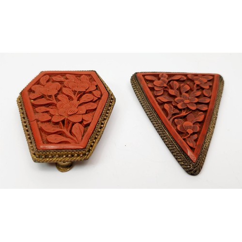 33 - Two antique clips set with carved cinnabar panels, one A/F, the longest 2