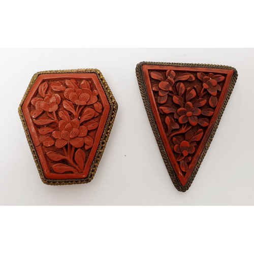 33 - Two antique clips set with carved cinnabar panels, one A/F, the longest 2