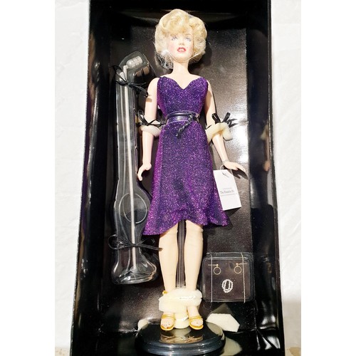 107 - A boxed Franklin Mint Marilyn Monroe Entertaining The Troops limited edition vinyl portrait doll, he... 