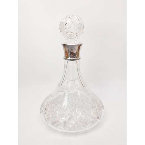 135 - A cut glass ship's decanter with a hallmarked silver collar, height 11.5