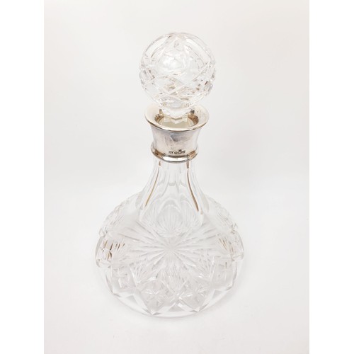 135 - A cut glass ship's decanter with a hallmarked silver collar, height 11.5