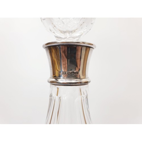 135 - A cut glass ship's decanter with a hallmarked silver collar, height 11.5