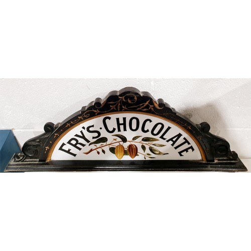 151 - An antique Fry's Chocolate carved wooden pediment from a shop display cabinet with an inset hand pai... 