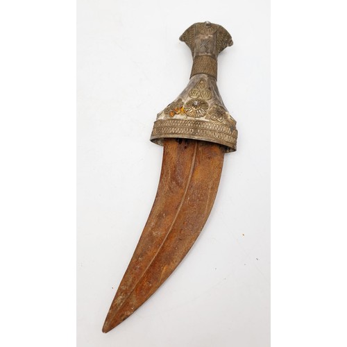 154 - An antique Middle Eastern / Omani Khanjar / Jambiya dagger covered in white metal, blade length 5