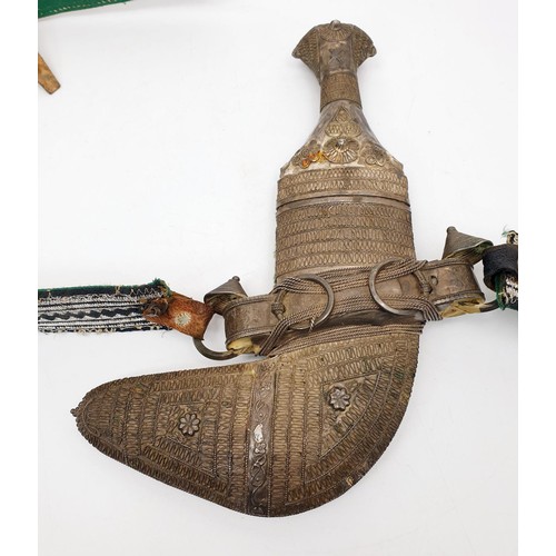 154 - An antique Middle Eastern / Omani Khanjar / Jambiya dagger covered in white metal, blade length 5