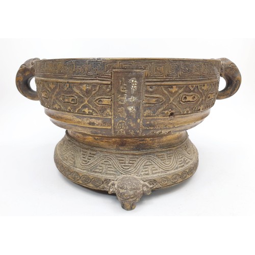 165 - An antique Chinese bronze censor having elephant handles, inscriptions and geometric patterns, diame... 