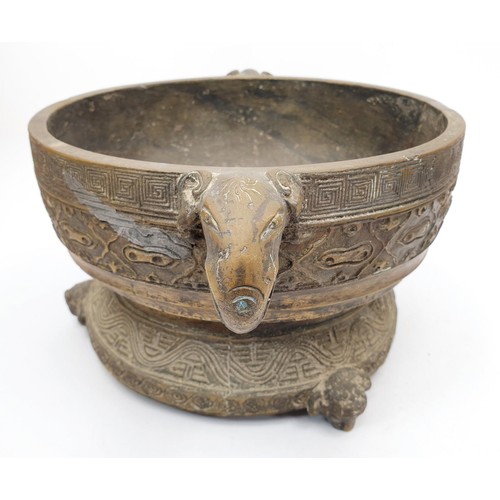 165 - An antique Chinese bronze censor having elephant handles, inscriptions and geometric patterns, diame... 