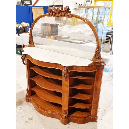 177 - A Victorian walnut credenza with mirror back surrounded by carved frame, marble top and four tier sh... 