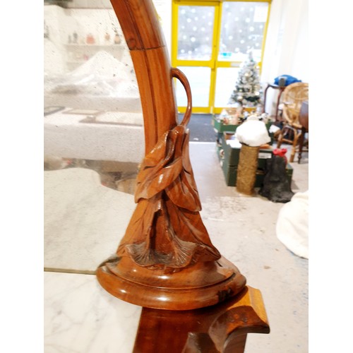 177 - A Victorian walnut credenza with mirror back surrounded by carved frame, marble top and four tier sh... 