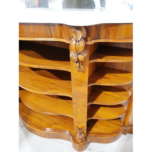 177 - A Victorian walnut credenza with mirror back surrounded by carved frame, marble top and four tier sh... 