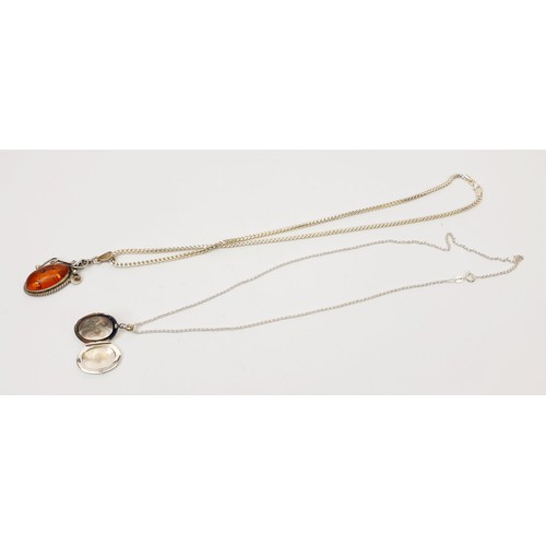 4 - A silver and amber pendant on a silver chain, chain length 19