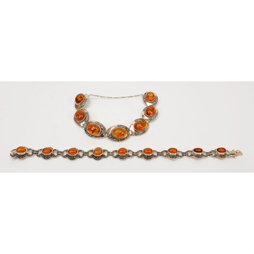 6 - Two silver and amber bracelets, the longest 8